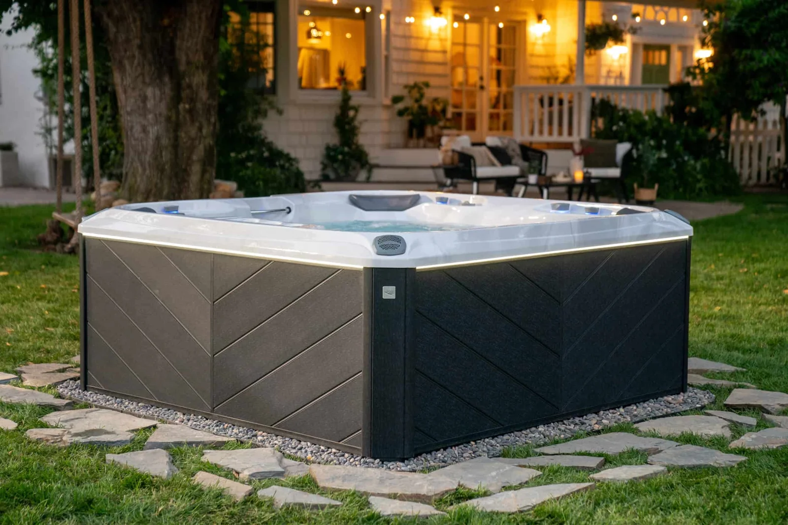 Sundance Optima hot tub clearly visible in a bright landscaped backyard