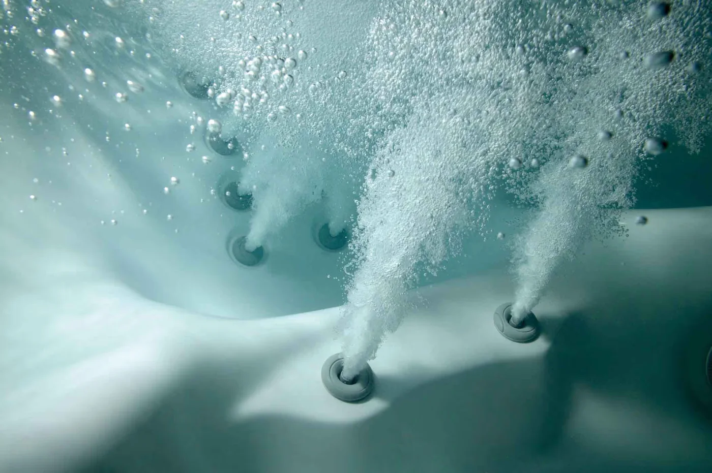 Close-up of Sundance hydrotherapy jets delivering an underwater massage