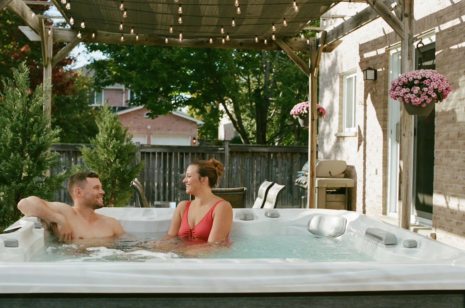 A couple sharing a relaxed conversation in a Sundance Chelsee hot tub